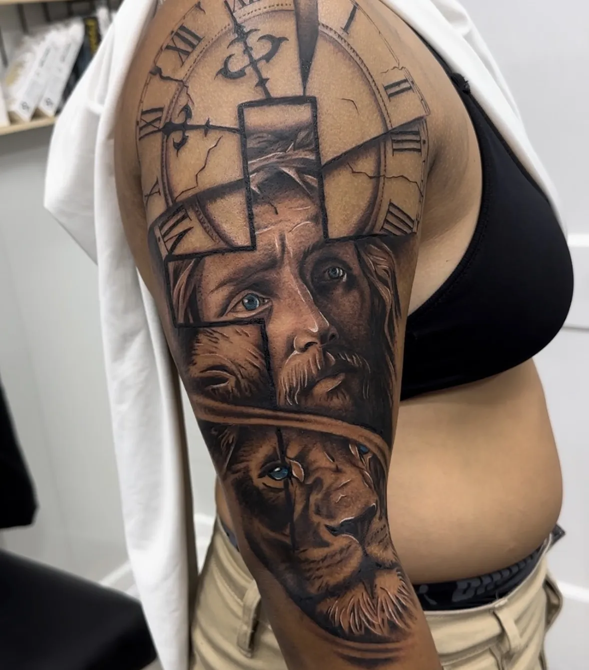Detailed black and grey arm tattoo