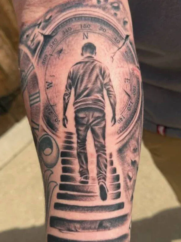 Black and grey tattoo of a figure walking through a surreal architectural scene