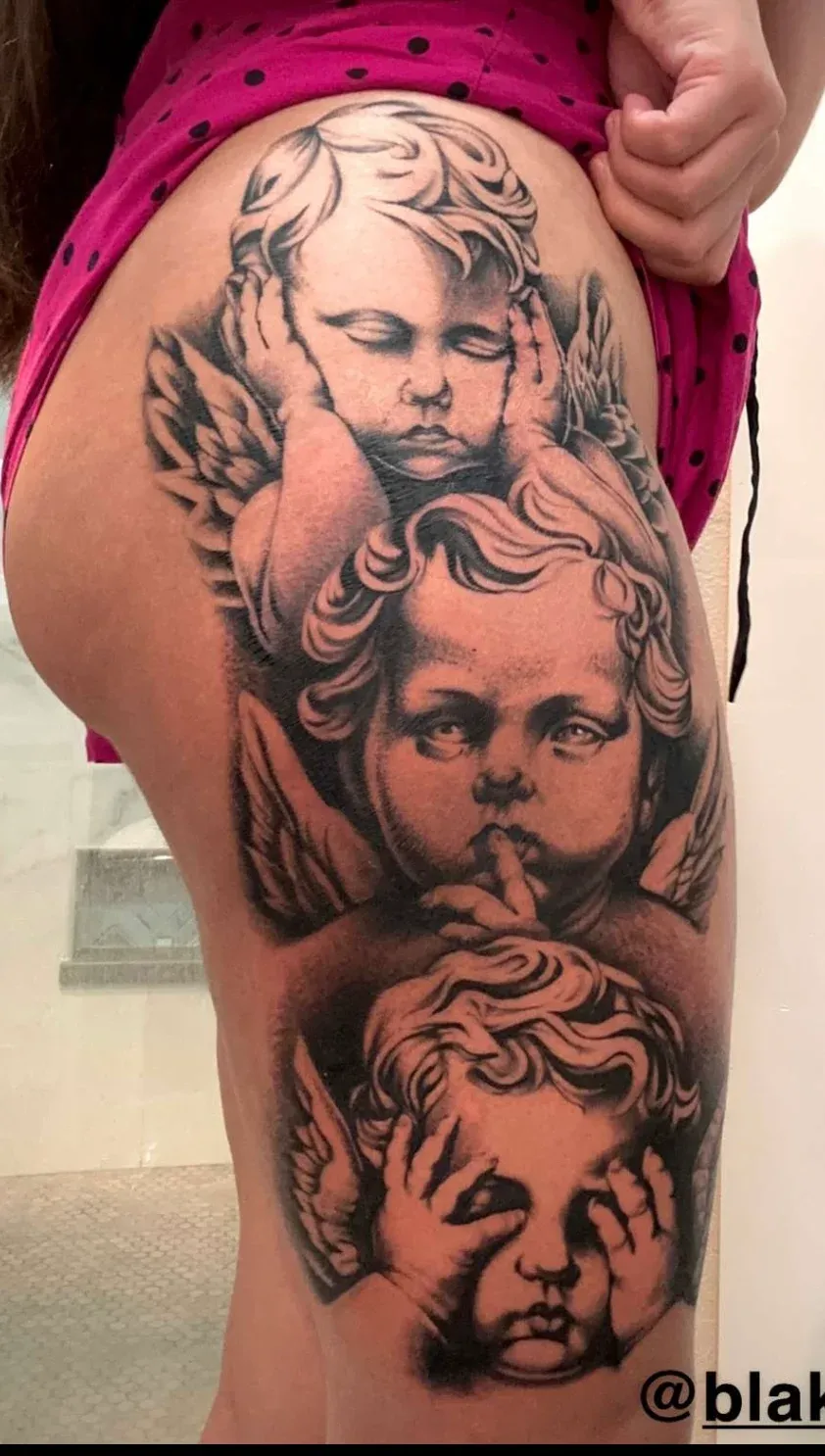 Black and grey cherub portrait tattoo