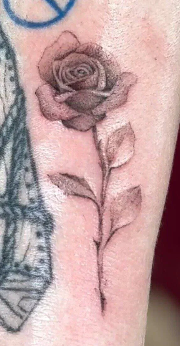Fine-line rose tattoo