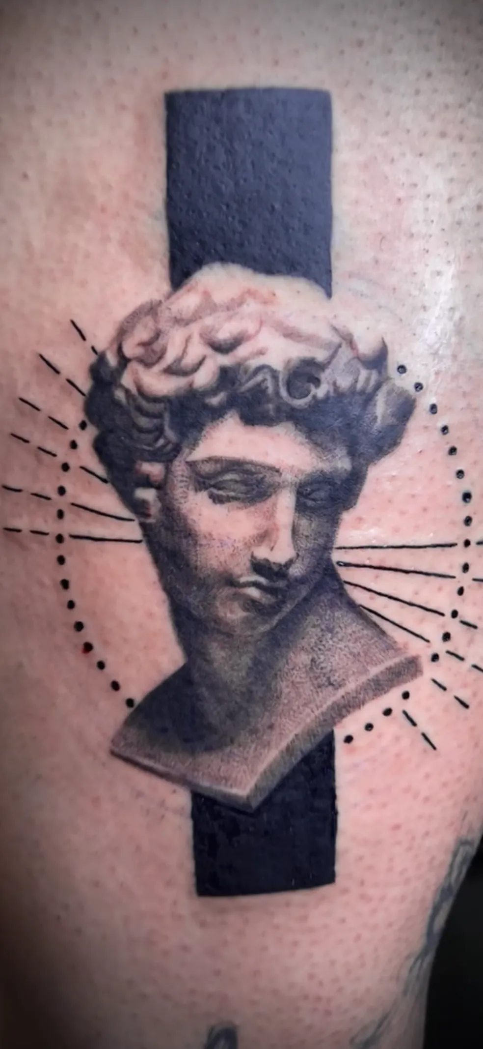 Classical bust tattoo with geometric black shapes