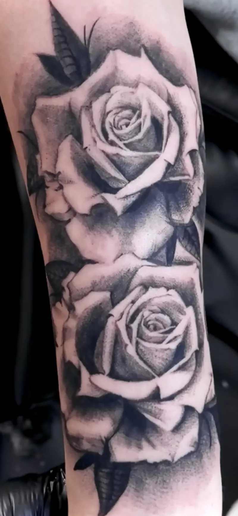 Black and grey rose sleeve tattoo